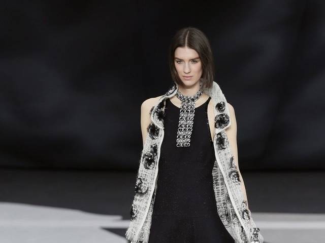 Karl Lagerfeld led the celebrations of the 100th anniversary of the French fashion house, in a show set around a huge globe dotted with 300 Chanel flags representing its stores around the world