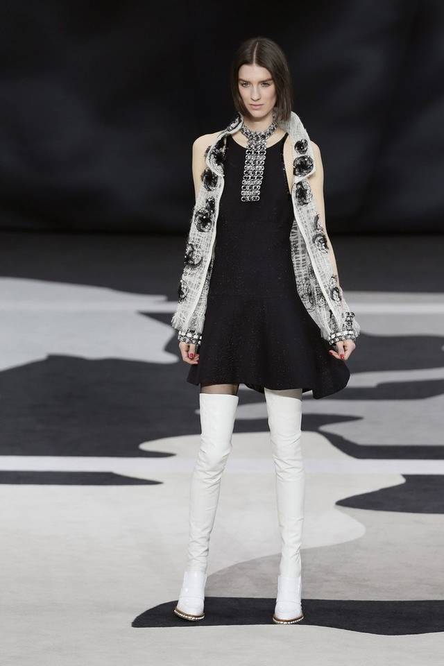 Karl Lagerfeld led the celebrations of the 100th anniversary of the French fashion house, in a show set around a huge globe dotted with 300 Chanel flags representing its stores around the world