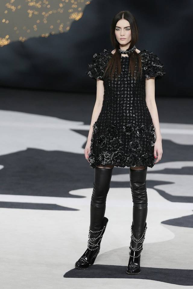 Karl Lagerfeld led the celebrations of the 100th anniversary of the French fashion house, in a show set around a huge globe dotted with 300 Chanel flags representing its stores around the world